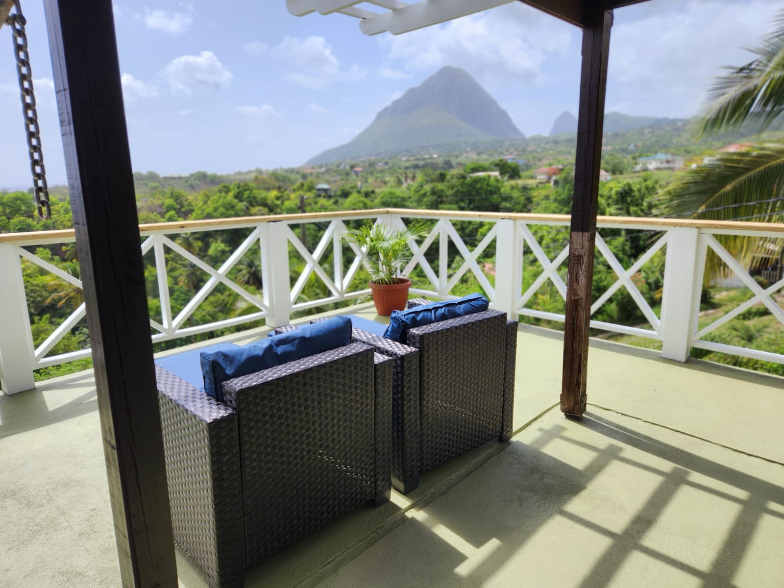 Covered terrace seating with panoramic Piton and hillside views