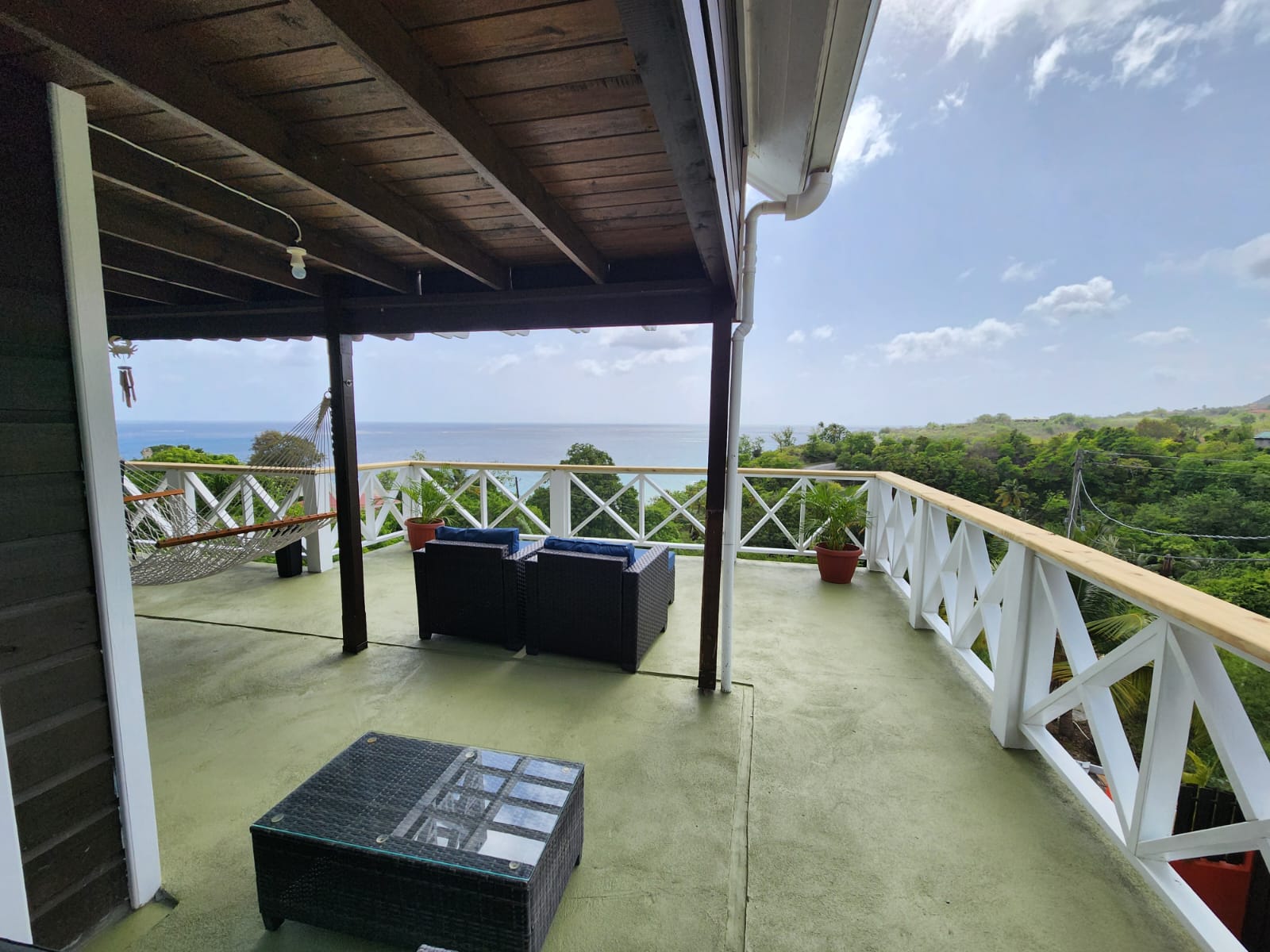 Wraparound terrace with hammock, seating, and ocean views